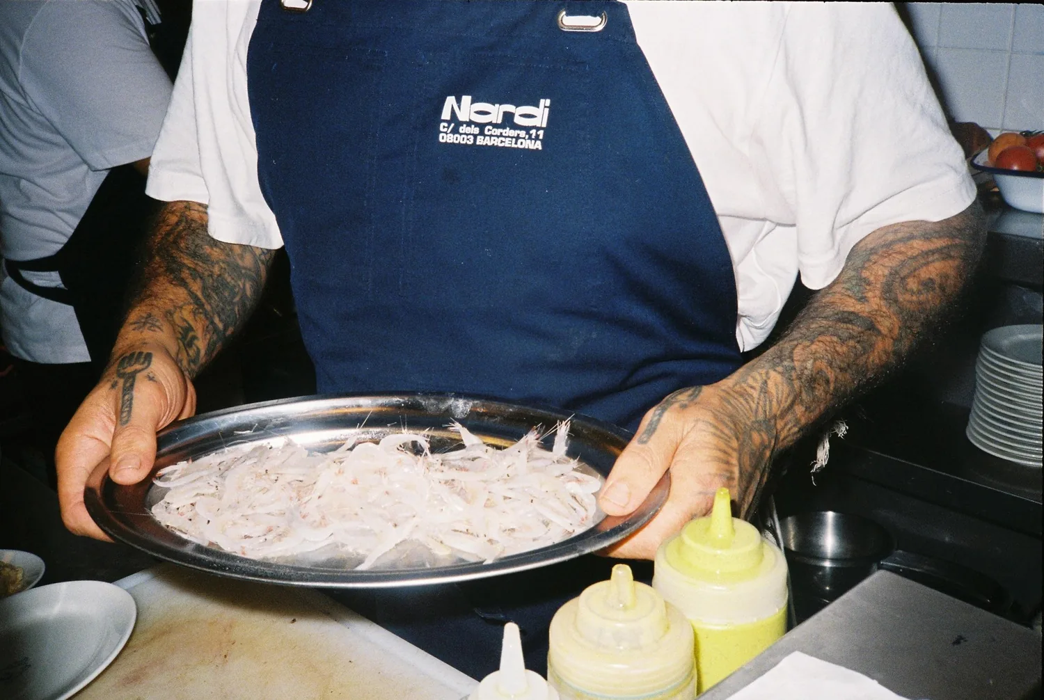 Cocinero de Nardi con una bandeja de gambas recién llegadas de la lonja